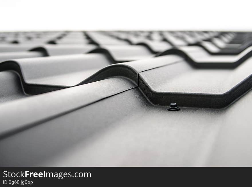 Abstraction of close up on corrugated metal roofing tiles in black and white. Abstraction of close up on corrugated metal roofing tiles in black and white.