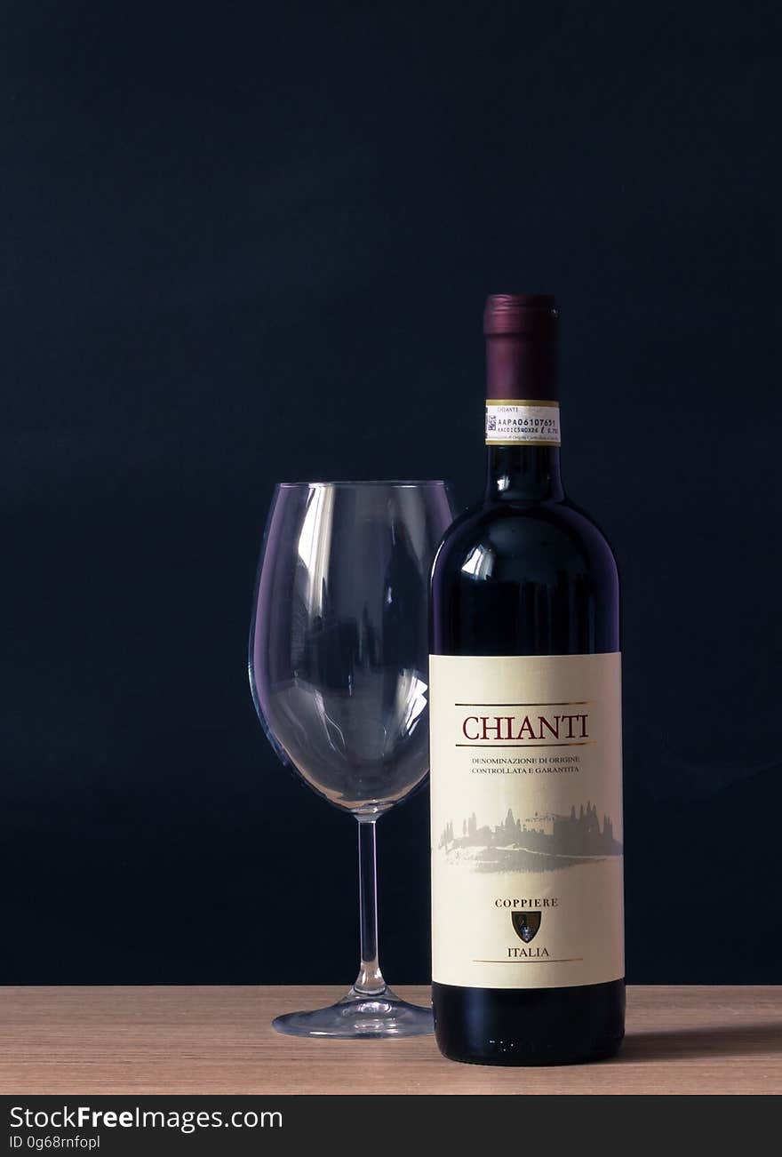 Chianti Labeled Bottle and Clear Long Stem Glass on Table