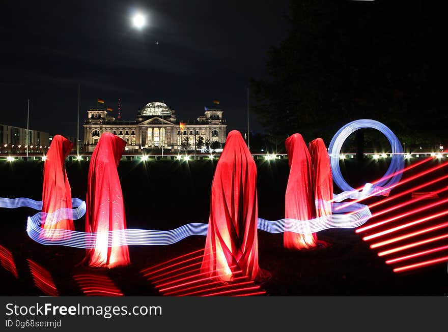 5 People Hiding Under Red Textile during Night