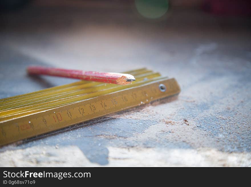 Red Pencil on Gold Metal Rulers