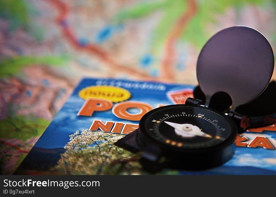 Open compass on map as travel concept.