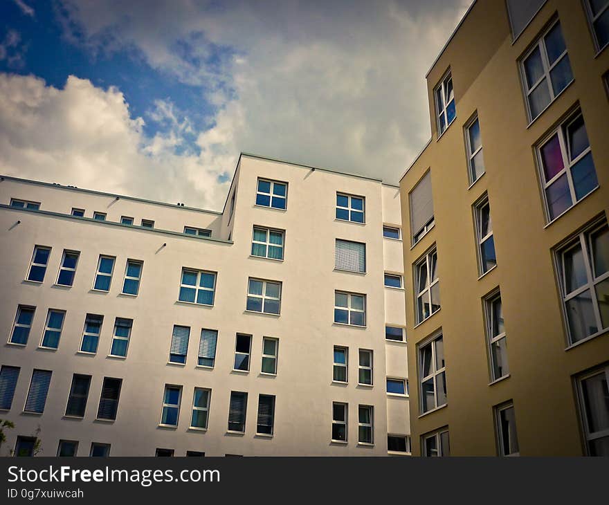 Exterior of modern office or apartment blocks against blue skies with white clouds. Exterior of modern office or apartment blocks against blue skies with white clouds.