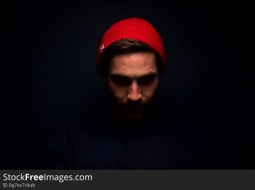 Studio portrait of man wearing red stocking hat. Studio portrait of man wearing red stocking hat.