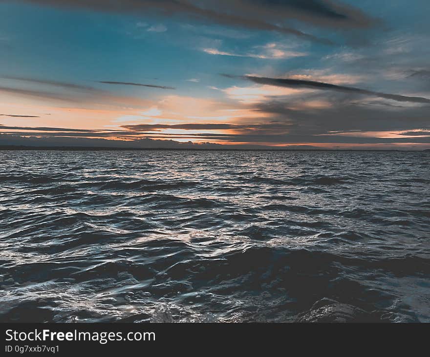 Sunset in horizon over ocean waves. Sunset in horizon over ocean waves.