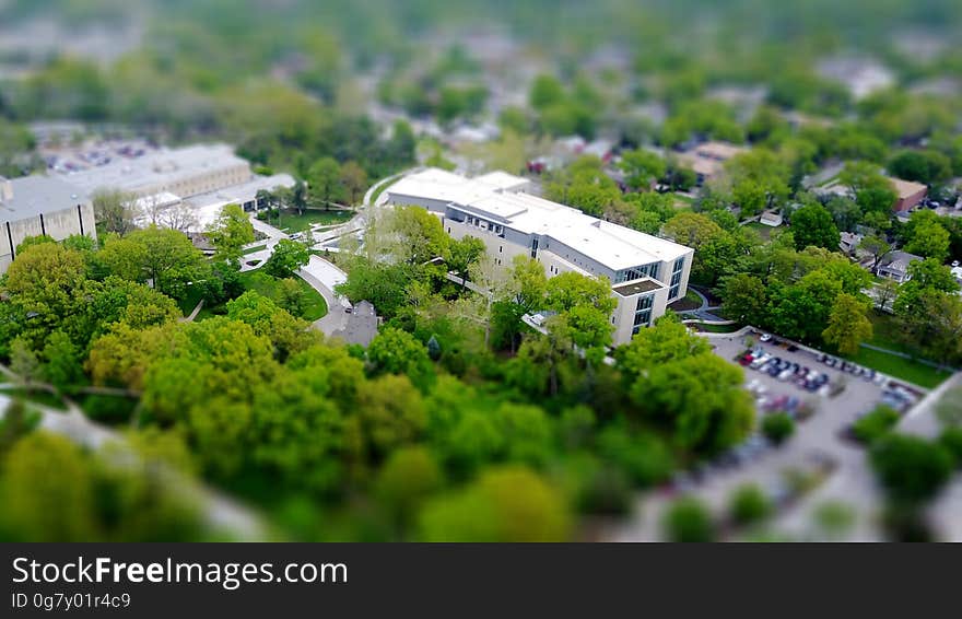 A tilt-shift view of buildings near a park in city. A tilt-shift view of buildings near a park in city.