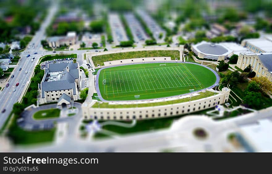 A model of a college building with a soccer field. A model of a college building with a soccer field.