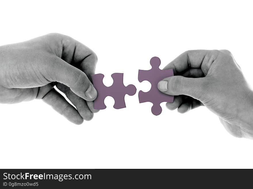 2 Hands Holding 1 Jigsaw Puzzle Piece Each