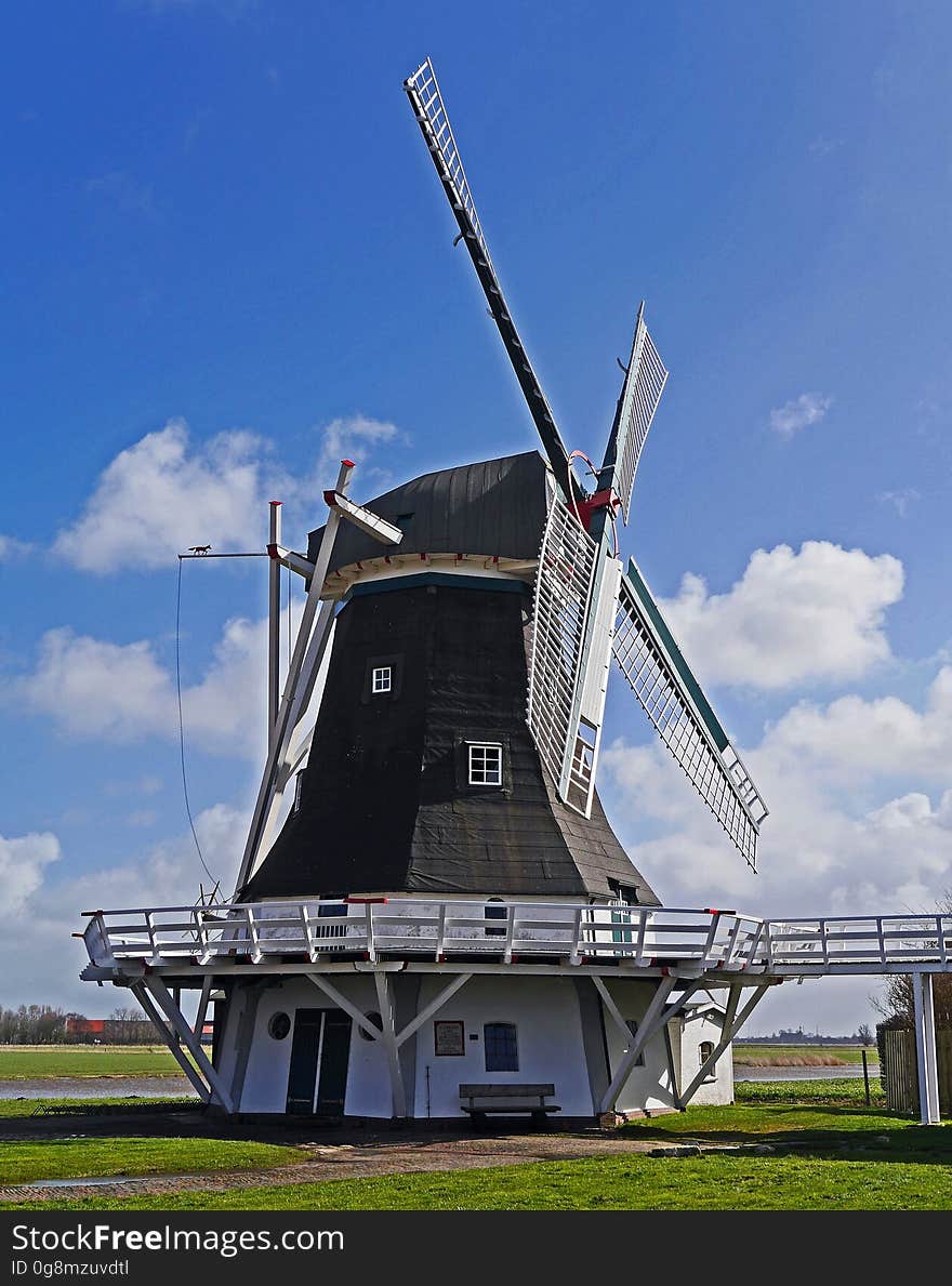 White and Black Wooden Windmill during Daytime