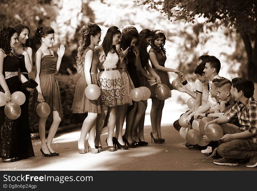 A group of teenagers in a school dance or graduation celebration.