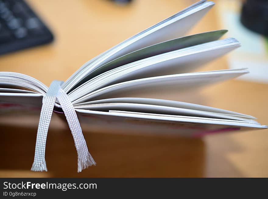 A close up of an open book on a table.