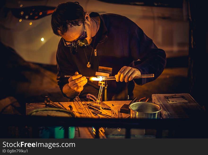 A man working on a workbench. A man working on a workbench.