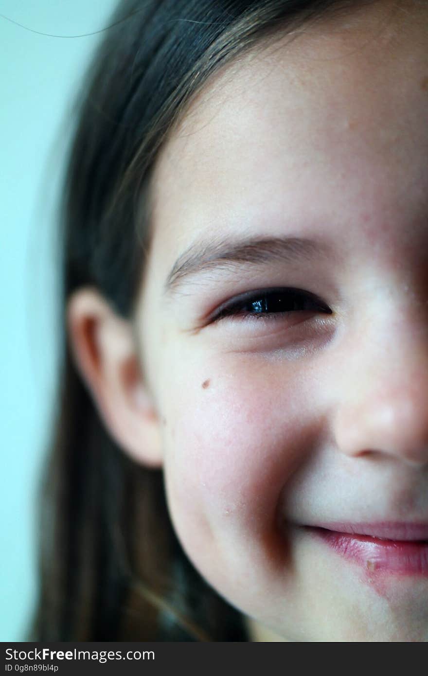 A close up of a smiling girl`s face.