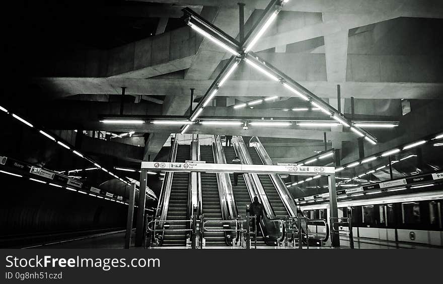 A view inside a subway station in black and white.