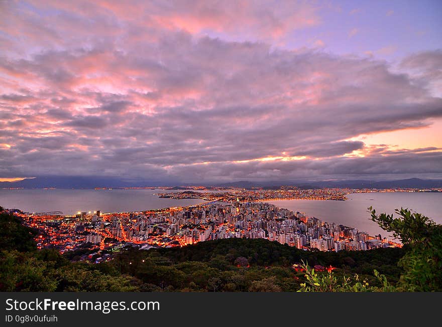 Photo of City Buildings Taken Up on the Mountain during Dusk