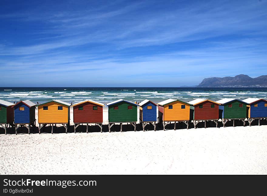 Colorful Cottages Near the Sea Under Blue Sky during Daytime