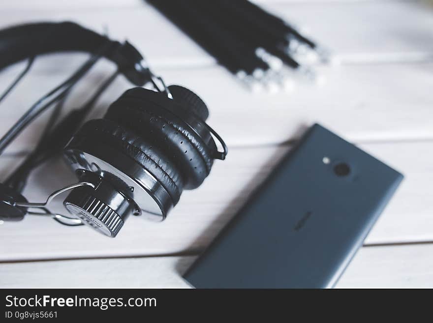 Closeup of headphones with smart phone