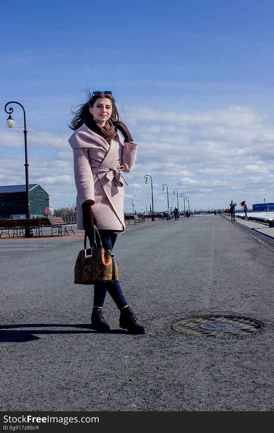 Beautiful young dark-haired girl on the waterfront.