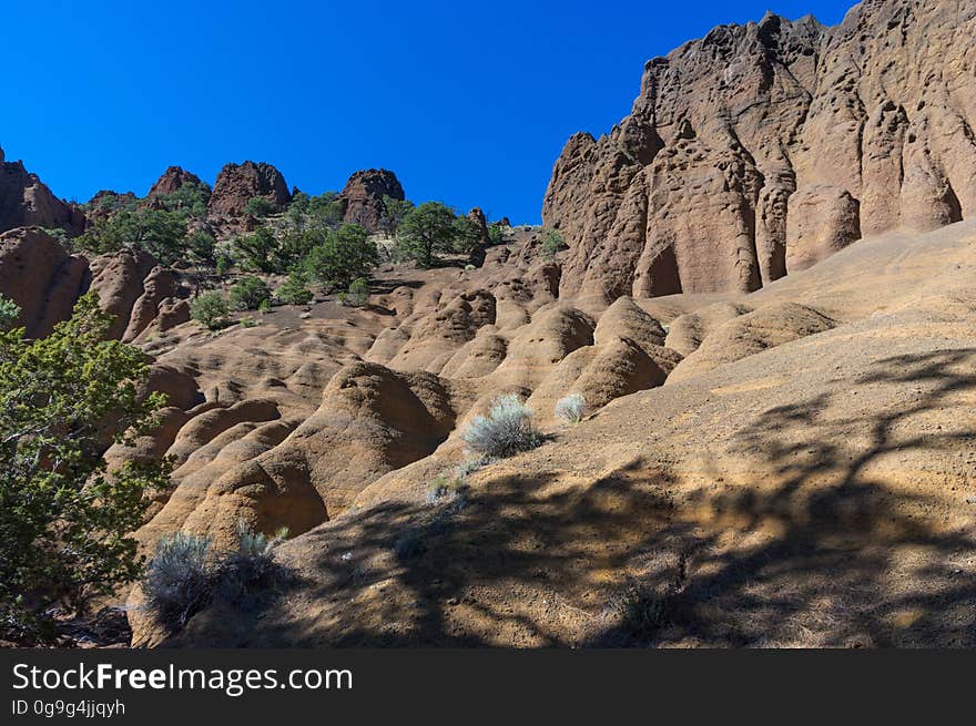 Red Mountain is a volcanic cinder cone that rises 1,000 feet above the surrounding landscape. It is unusual in having the shape of a &quot;U,&quot; and in lacking the symmetrical shape of most cinder cones. In addition, a large natural amphitheater cuts into the cone&#x27;s northeast flank. Erosional pillars called &quot;hoodoos&quot; decorate the amphitheater, and many dark mineral crystals erode out of its walls. Studies by U.S. Geological Survey &#x28;USGS&#x29; and Northern Arizona University scientists suggest that Red Mountain formed in eruptions about 740,000 years ago. The trailhead is located on U.S. Highway 180, 25 miles northwest of Flagstaff, Arizona. The trail is an easy 1.5 miles through open terrain with fantastic views of the San Francisco Peaks and surrounding San Francisco Volcanic Field. There is a short &#x28;approximately 6 feet&#x29; ladder climb required just before entering the natural amphitheater of the cinder cone. Photo by Deborah Lee Soltesz, October 2010. Credit: U.S. Forest Service, Coconino National Forest. For more information about this trail, see the Red Mountain Trail #159 trail description on the Coconino National Forest website. Red Mountain is a volcanic cinder cone that rises 1,000 feet above the surrounding landscape. It is unusual in having the shape of a &quot;U,&quot; and in lacking the symmetrical shape of most cinder cones. In addition, a large natural amphitheater cuts into the cone&#x27;s northeast flank. Erosional pillars called &quot;hoodoos&quot; decorate the amphitheater, and many dark mineral crystals erode out of its walls. Studies by U.S. Geological Survey &#x28;USGS&#x29; and Northern Arizona University scientists suggest that Red Mountain formed in eruptions about 740,000 years ago. The trailhead is located on U.S. Highway 180, 25 miles northwest of Flagstaff, Arizona. The trail is an easy 1.5 miles through open terrain with fantastic views of the San Francisco Peaks and surrounding San Francisco Volcanic Field. There is a short &#x28;approximately 6 feet&#x29; ladder climb required just before entering the natural amphitheater of the cinder cone. Photo by Deborah Lee Soltesz, October 2010. Credit: U.S. Forest Service, Coconino National Forest. For more information about this trail, see the Red Mountain Trail #159 trail description on the Coconino National Forest website.