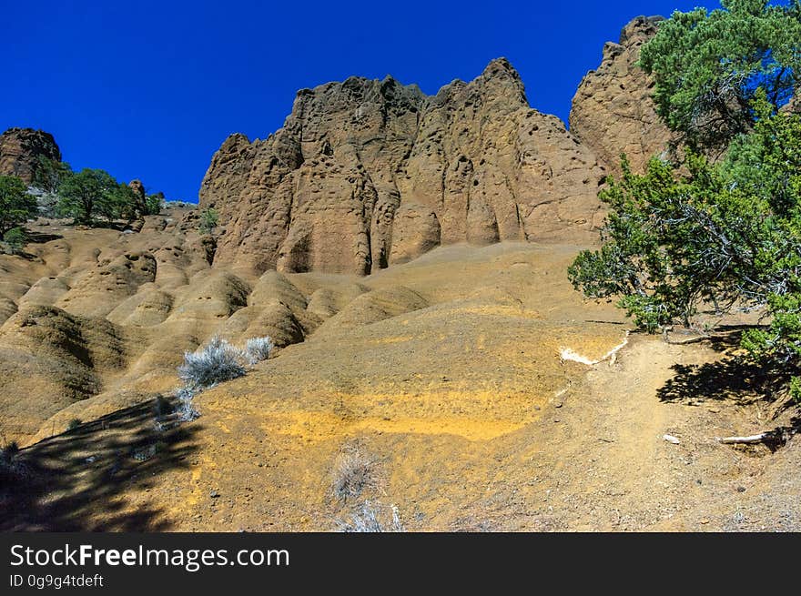 Red Mountain is a volcanic cinder cone that rises 1,000 feet above the surrounding landscape. It is unusual in having the shape of a &quot;U,&quot; and in lacking the symmetrical shape of most cinder cones. In addition, a large natural amphitheater cuts into the cone&#x27;s northeast flank. Erosional pillars called &quot;hoodoos&quot; decorate the amphitheater, and many dark mineral crystals erode out of its walls. Studies by U.S. Geological Survey &#x28;USGS&#x29; and Northern Arizona University scientists suggest that Red Mountain formed in eruptions about 740,000 years ago. The trailhead is located on U.S. Highway 180, 25 miles northwest of Flagstaff, Arizona. The trail is an easy 1.5 miles through open terrain with fantastic views of the San Francisco Peaks and surrounding San Francisco Volcanic Field. There is a short &#x28;approximately 6 feet&#x29; ladder climb required just before entering the natural amphitheater of the cinder cone. Photo by Deborah Lee Soltesz, February 2015. Credit: U.S. Forest Service, Coconino National Forest. For more information about this trail, see the Red Mountain Trail #159 trail description on the Coconino National Forest website. Red Mountain is a volcanic cinder cone that rises 1,000 feet above the surrounding landscape. It is unusual in having the shape of a &quot;U,&quot; and in lacking the symmetrical shape of most cinder cones. In addition, a large natural amphitheater cuts into the cone&#x27;s northeast flank. Erosional pillars called &quot;hoodoos&quot; decorate the amphitheater, and many dark mineral crystals erode out of its walls. Studies by U.S. Geological Survey &#x28;USGS&#x29; and Northern Arizona University scientists suggest that Red Mountain formed in eruptions about 740,000 years ago. The trailhead is located on U.S. Highway 180, 25 miles northwest of Flagstaff, Arizona. The trail is an easy 1.5 miles through open terrain with fantastic views of the San Francisco Peaks and surrounding San Francisco Volcanic Field. There is a short &#x28;approximately 6 feet&#x29; ladder climb required just before entering the natural amphitheater of the cinder cone. Photo by Deborah Lee Soltesz, February 2015. Credit: U.S. Forest Service, Coconino National Forest. For more information about this trail, see the Red Mountain Trail #159 trail description on the Coconino National Forest website.