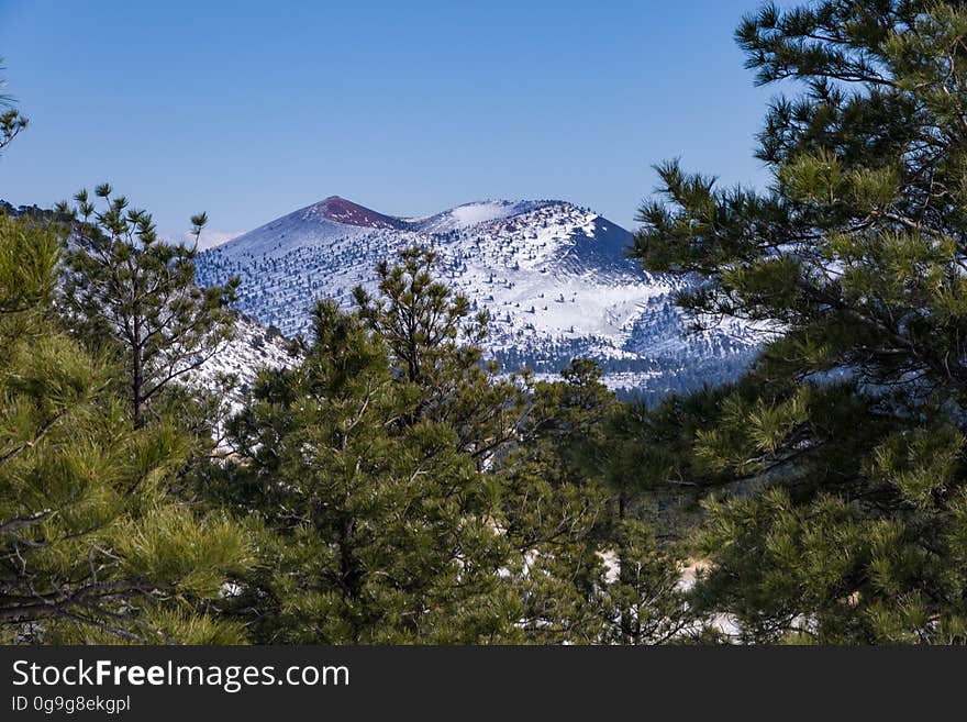 A winter storm December 24, 2016 brough a white Christmas across the state, with several inches to a foot falling around the Flagstaff, Arizona area. View of Sunset Crater Volcano from northeast of the San Francisco Peaks, hiking on FR 9125 into an unnamed crater. Photo by Deborah Lee Soltesz, December 25, 2016. Credit: Coconino National Forest, U.S. Forest Service.