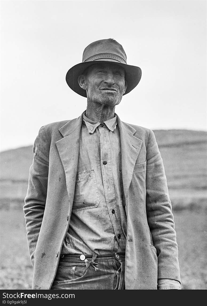 Grayscale Portrait of a Man in Suit Jacket and Panama Hat