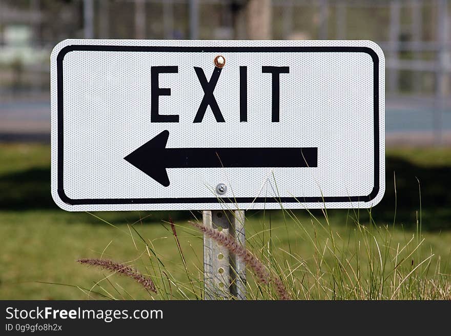 An exit sign with a pointing arrow.