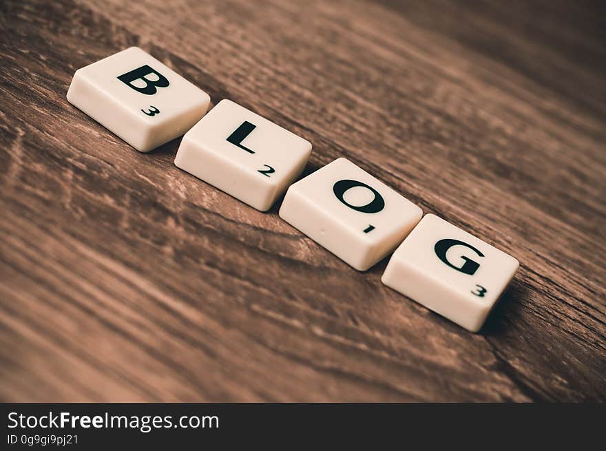 Scrabble tiles forming the word blog on a wooden background. Scrabble tiles forming the word blog on a wooden background.