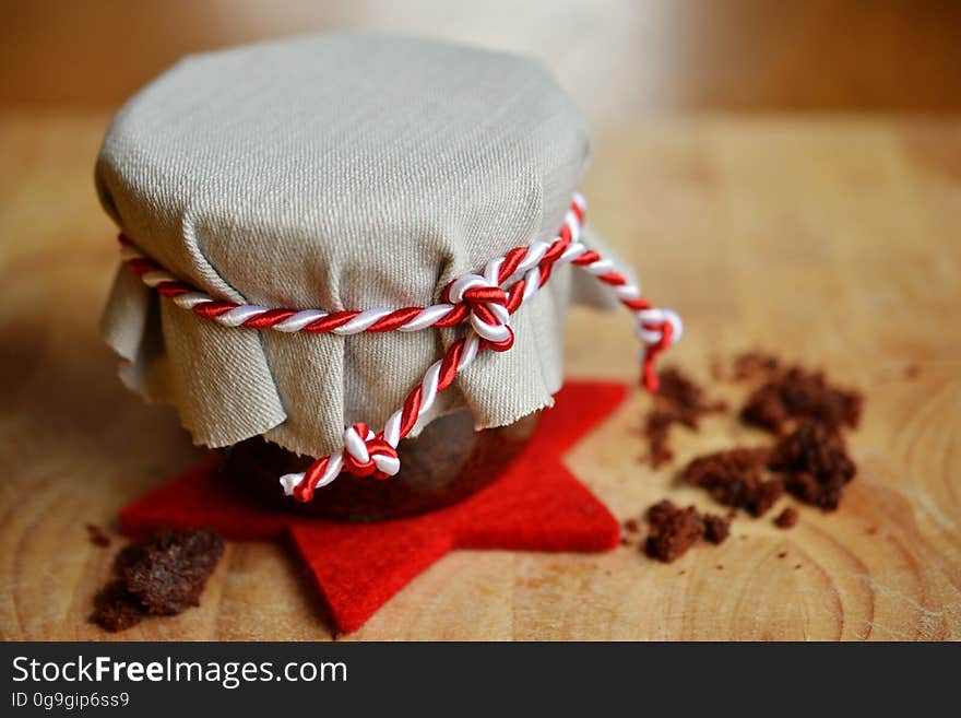 A chocolate cake in a jar with a cloth cover and red and white string. A chocolate cake in a jar with a cloth cover and red and white string.