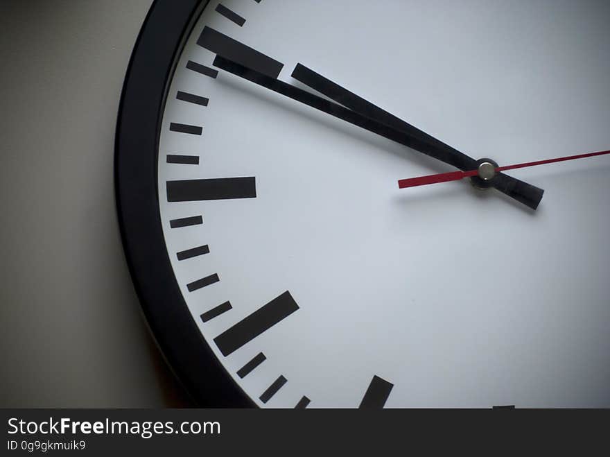 A close up of a clock face at ten minutes to ten.