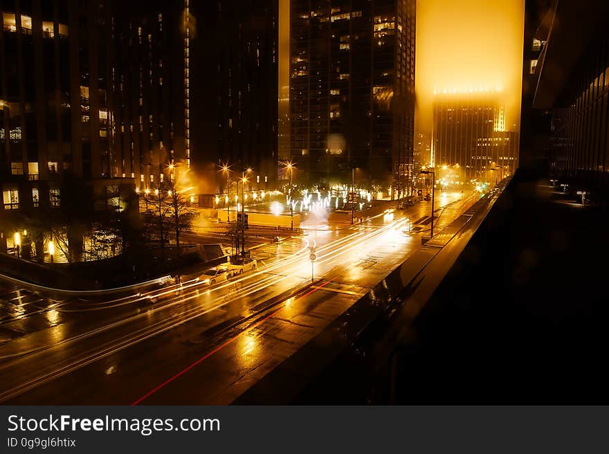 A view of the streets of a city at night with traffic. A view of the streets of a city at night with traffic.