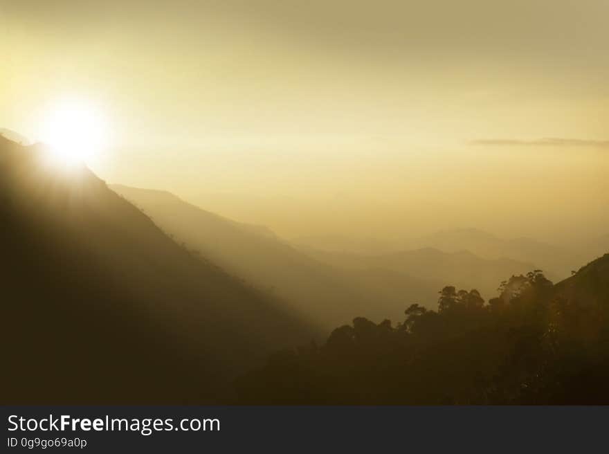 A view of hazy mountains at sunset. A view of hazy mountains at sunset.