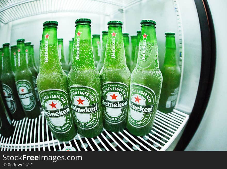 A refrigerator full of bottles of beer. A refrigerator full of bottles of beer.