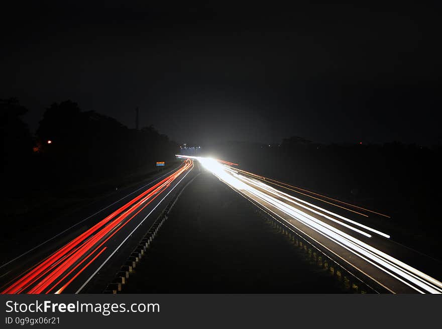 Time lapse view of motor car lights on highway at night.