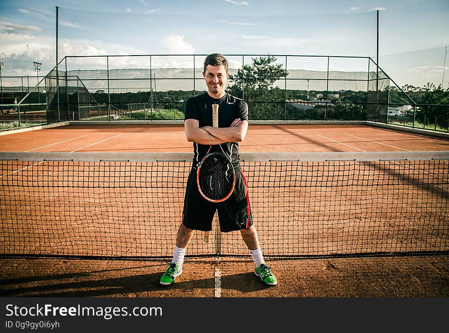 A tennis player stands on a court.