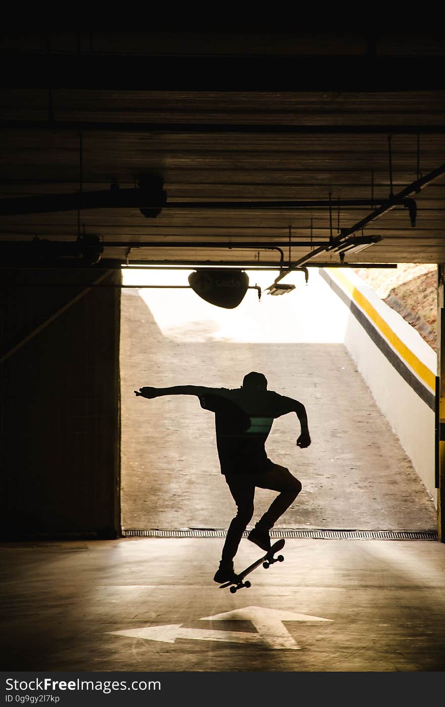 A silhouette of an underground skateboarder. A silhouette of an underground skateboarder.