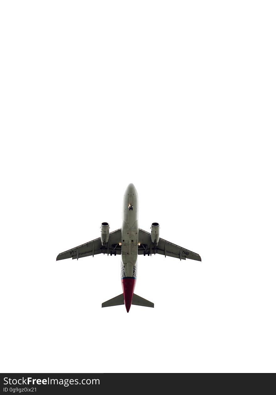 A large aircraft with two turbojet engines seen from below on white background.