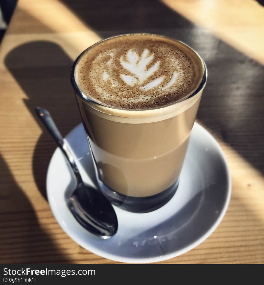 A latte art drawing on a cup of coffee on a table.