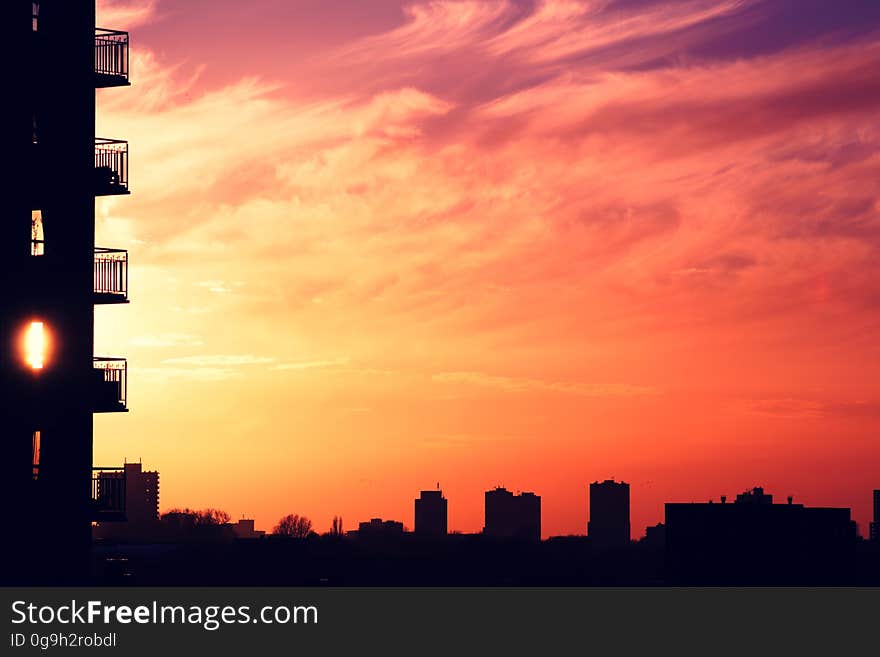 A view of an urban city with colorful sunset on the sky. A view of an urban city with colorful sunset on the sky.