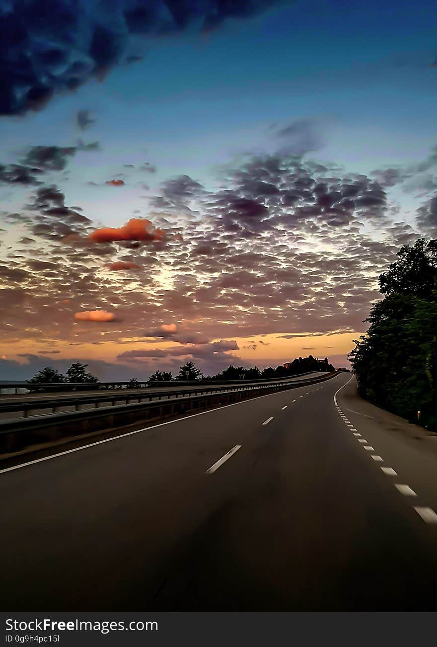 A sunset over a highway scene. A sunset over a highway scene.