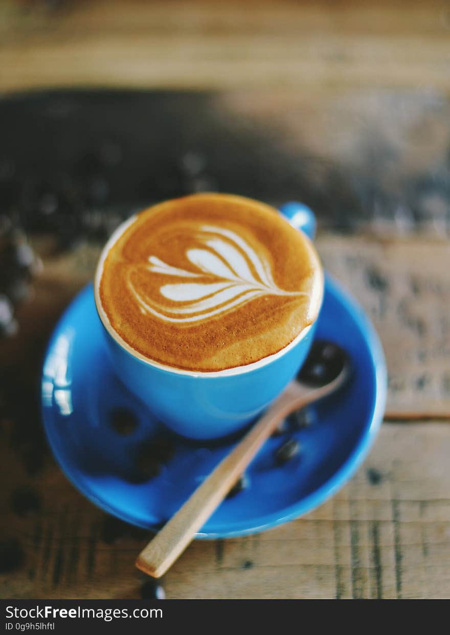 A hot latte on a wooden table.