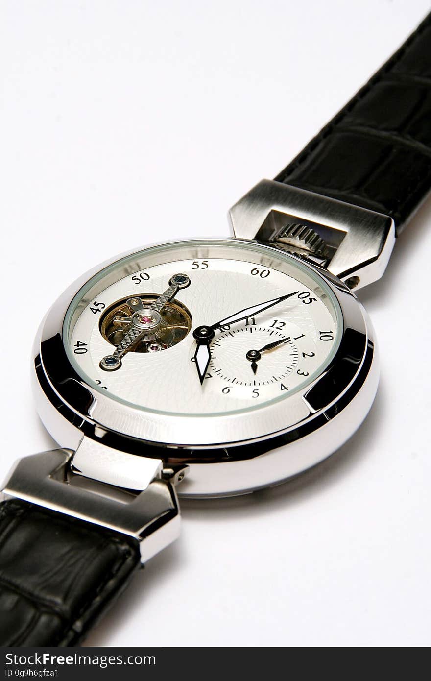 A close up of a men's wrist watch on a white background. A close up of a men's wrist watch on a white background.