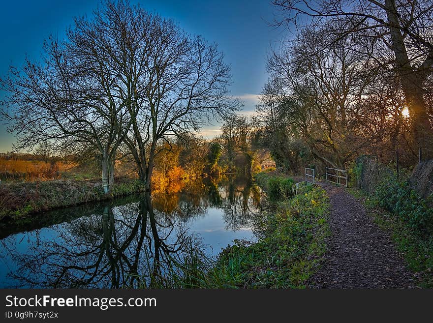 A blue calm river with the sunset on the sky. A blue calm river with the sunset on the sky.