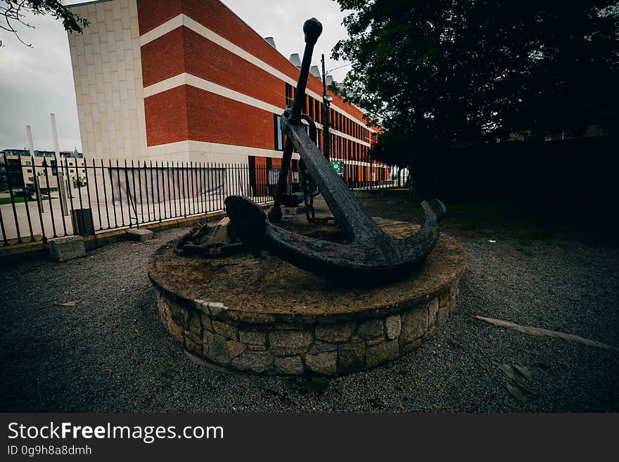 An old monument with an anchor on a stone pedestal. An old monument with an anchor on a stone pedestal.