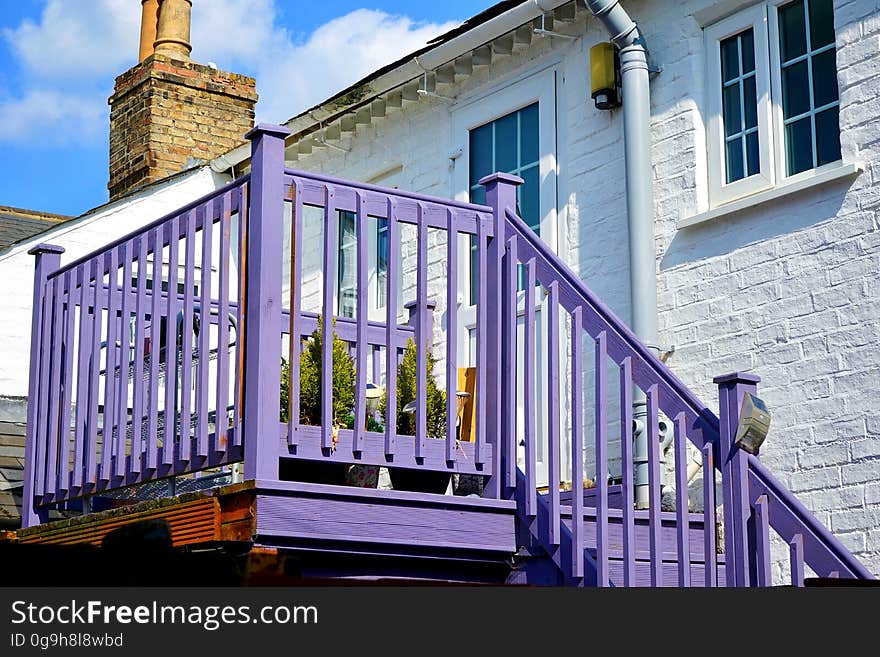 A stone house with violet balcony and stairs. A stone house with violet balcony and stairs.