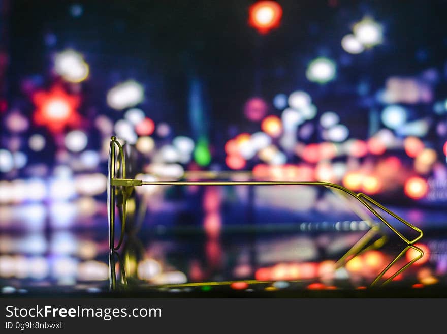 A pair of sunglasses with a bokeh background. A pair of sunglasses with a bokeh background.