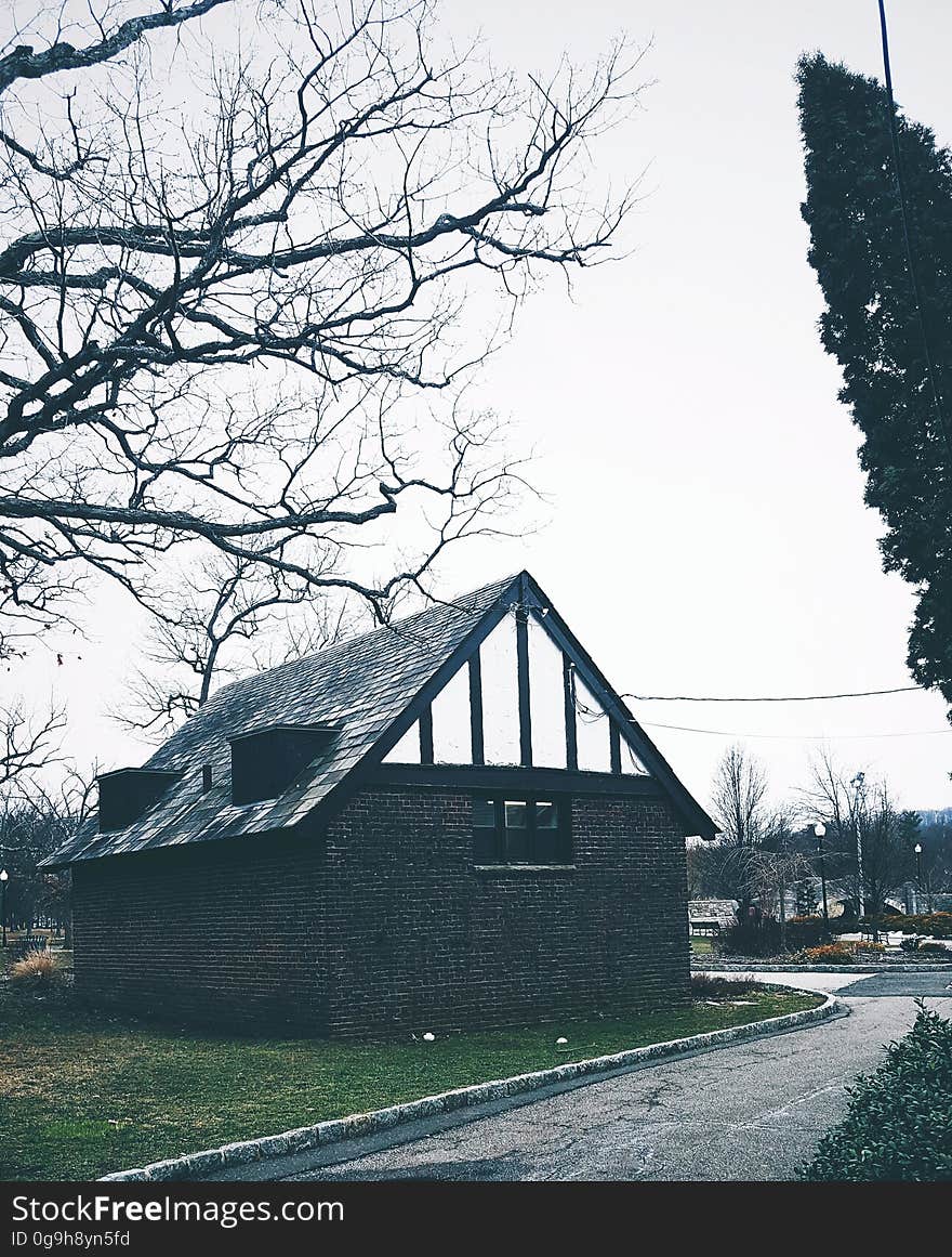 An old stone house by a street.