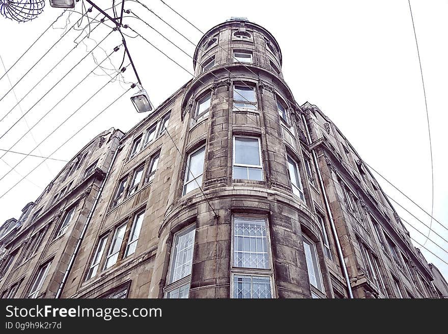 Apartments on several floors built in an unusual architectural style (maybe Victorian) with rounded corners and 'turret' on top. Apartments on several floors built in an unusual architectural style (maybe Victorian) with rounded corners and 'turret' on top.