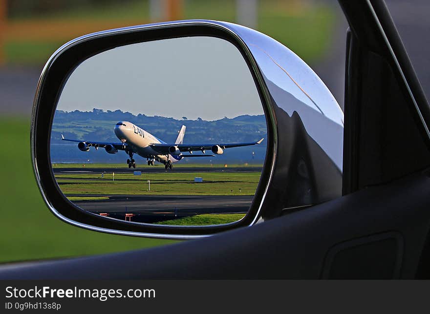 White Airplane Reflection on Car Side Mirror