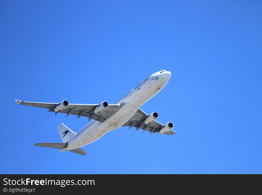 White Passenger Plane Flying on Sky during Day Time