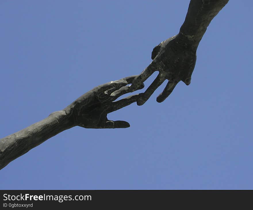 One hand reaches another... statues outside a Department of Education building in Calgary. One hand reaches another... statues outside a Department of Education building in Calgary